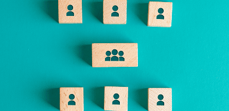 People icons on building blocks